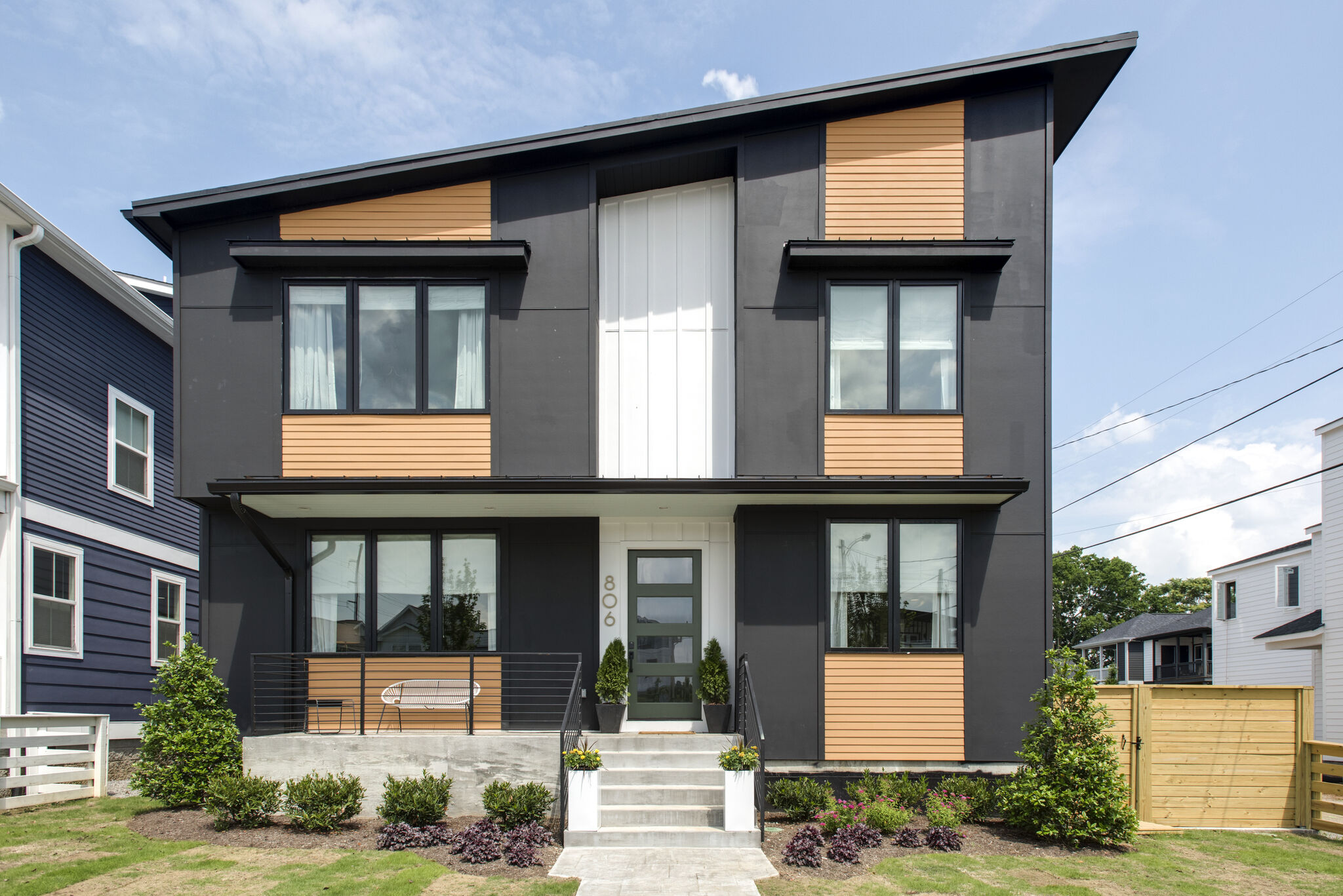 806 45th Ave with a sloping roofline, dark siding and warm wood accents