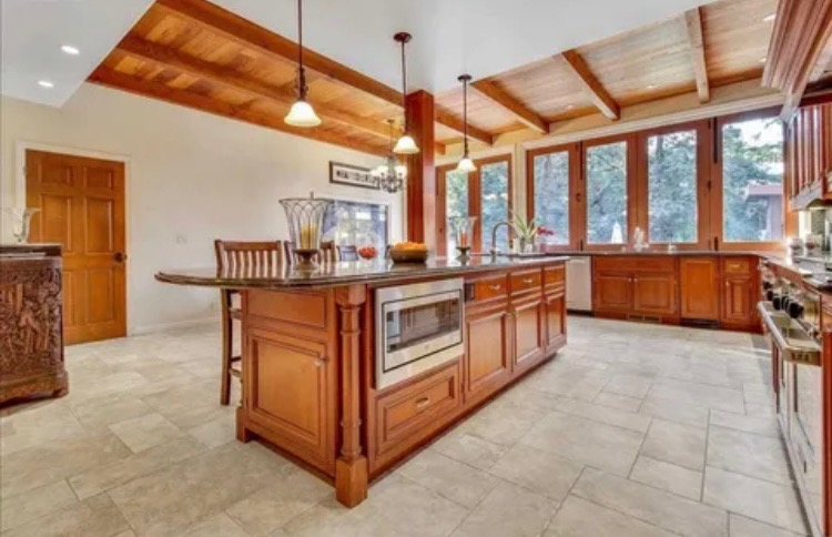 JC Construction kitchen renovation with exposed wood beams and large windows